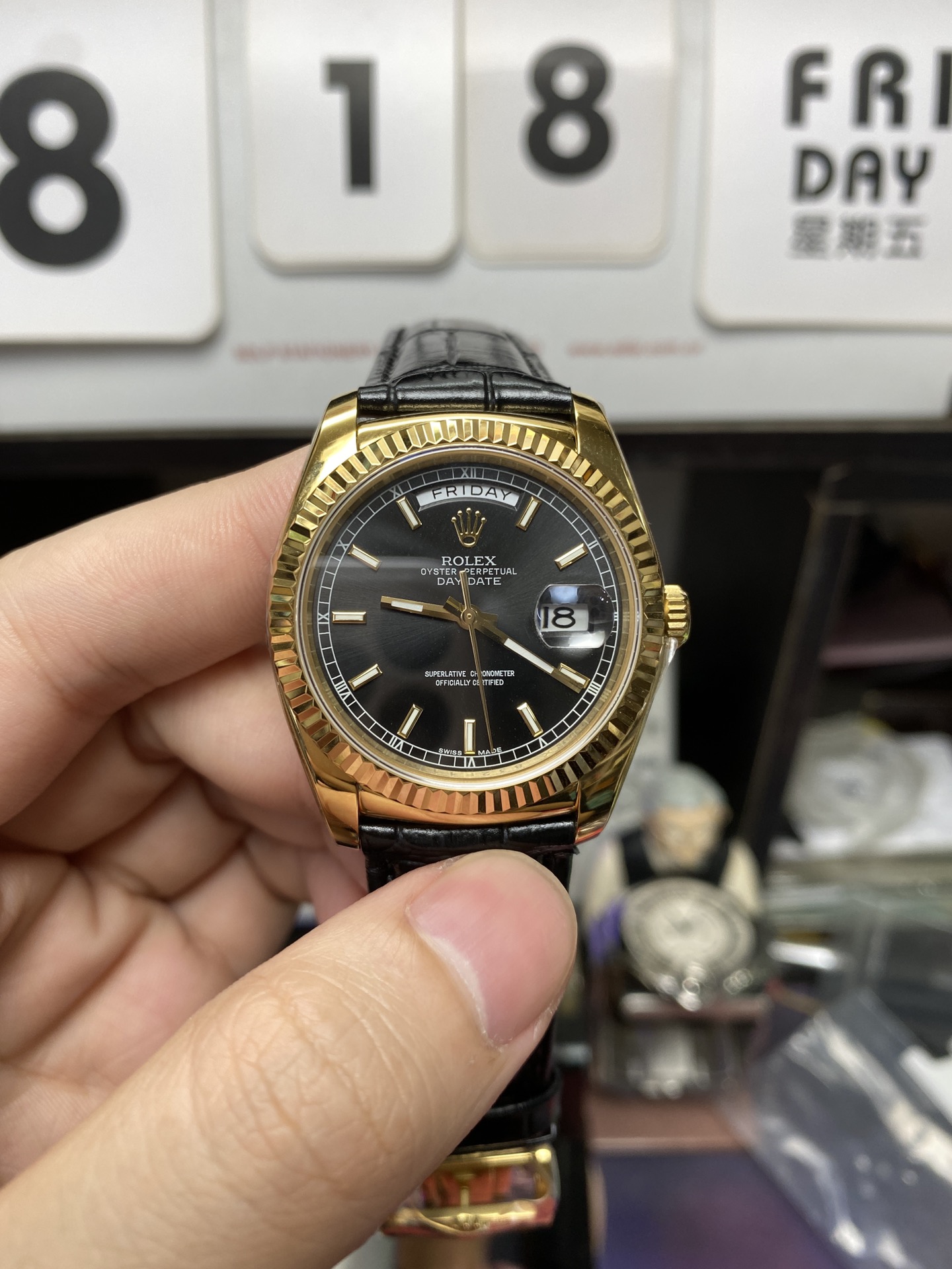 Rolex Day-Date Series 118135, Black Dial Gold Case with a leather strap, 36mm size.