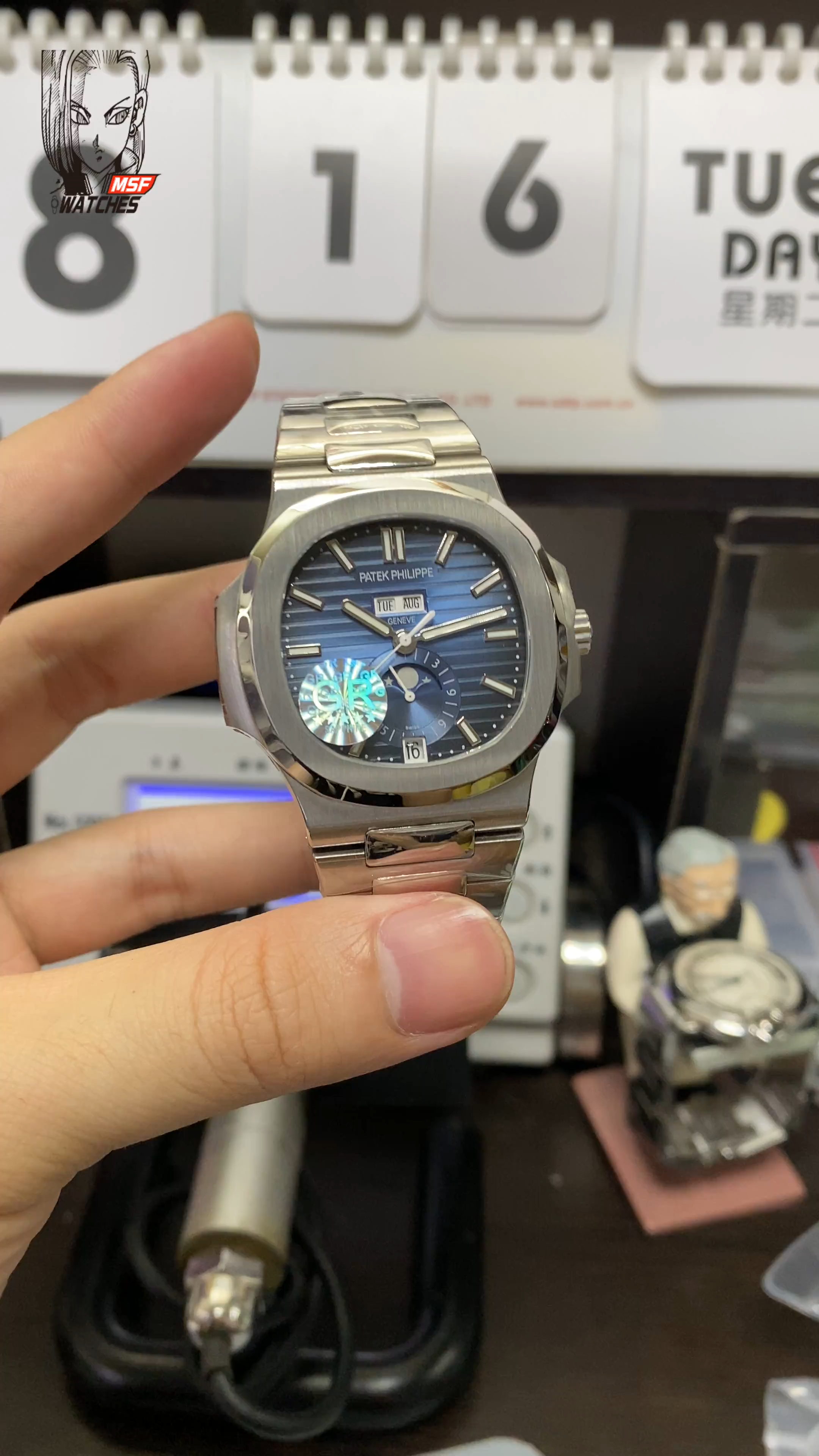 Patek Philippe Nautilus series 57261A-014, Blue Dial Steel Bracelet, Moon Phase Calendar Central Month and Week Display, 40.5mm Size.