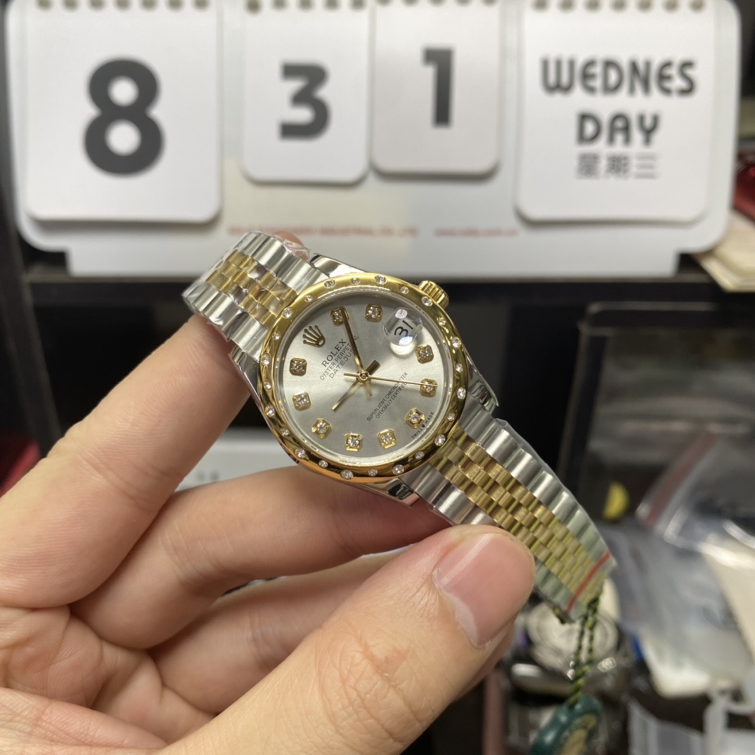 Rolex Datejust Series 178343-63163, Two-Tone Gold Case Silver Dial with Diamond Hour Markers Round Arched Bezel Set with Diamonds, 31mm Size, Five-Link Steel Bracelet.