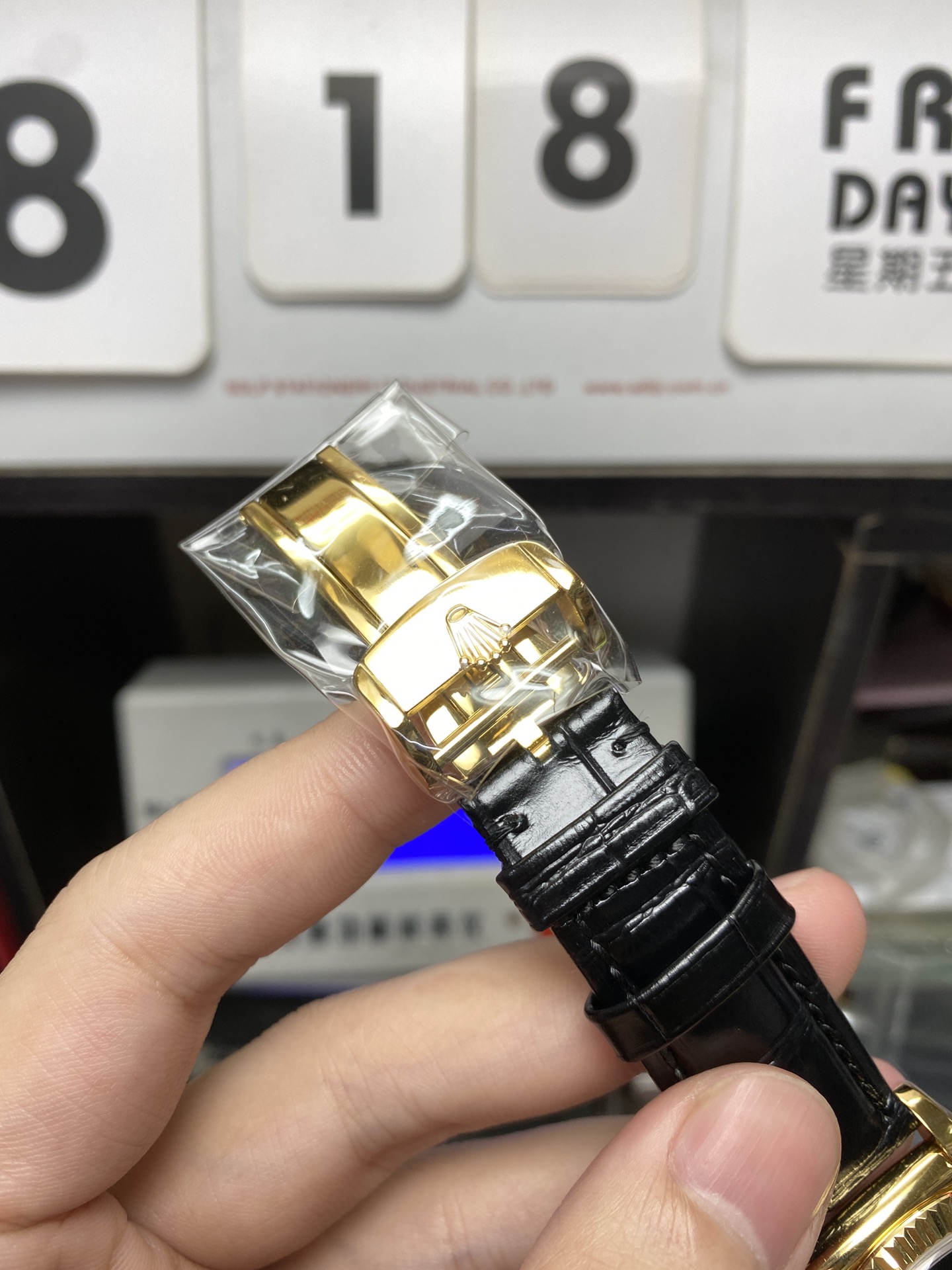 Rolex Day-Date Series 118135, Black Dial Gold Case with a leather strap, 36mm size.